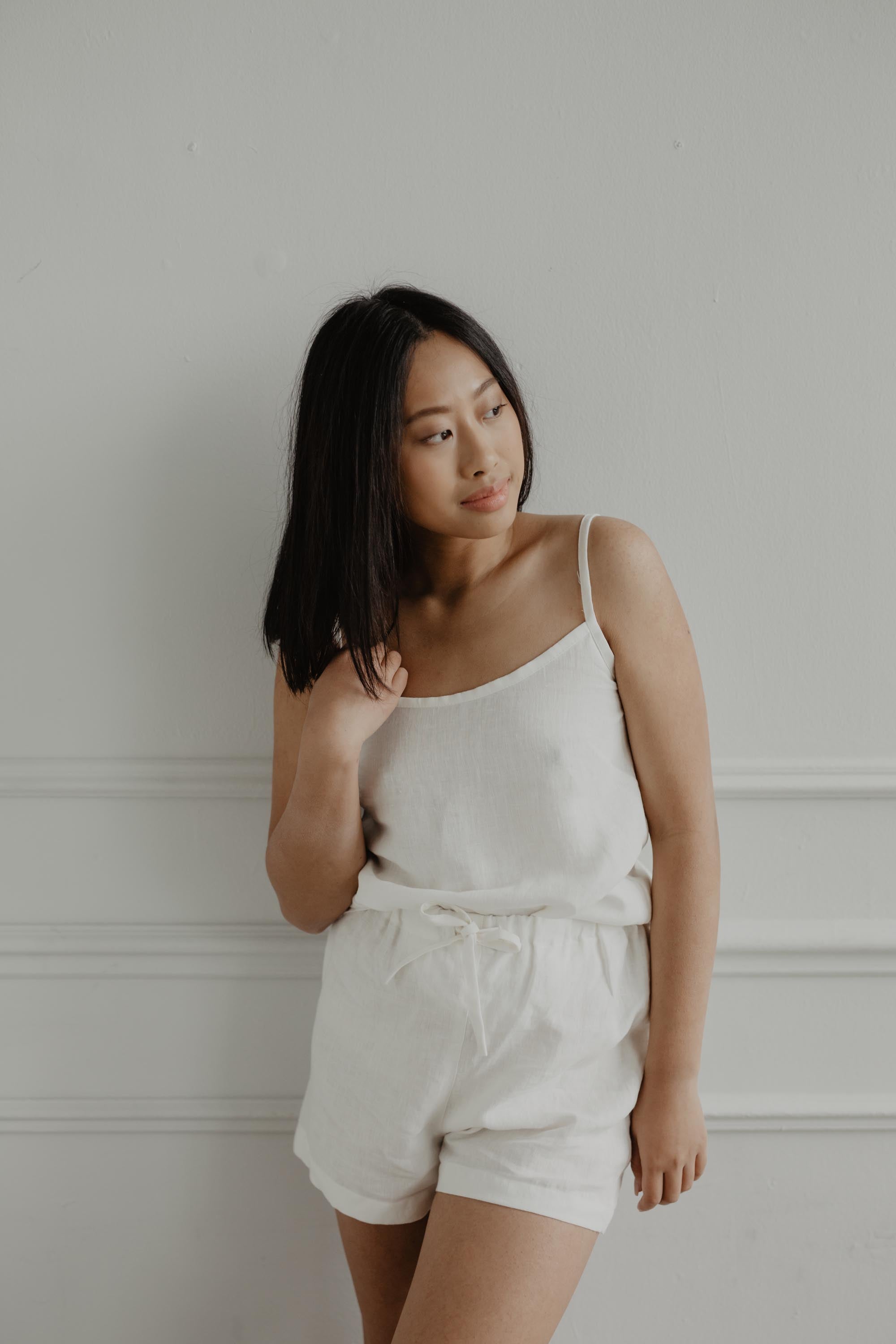 Woman Wearing A White Sleeveless Linen Pajama Set By Amourlinen