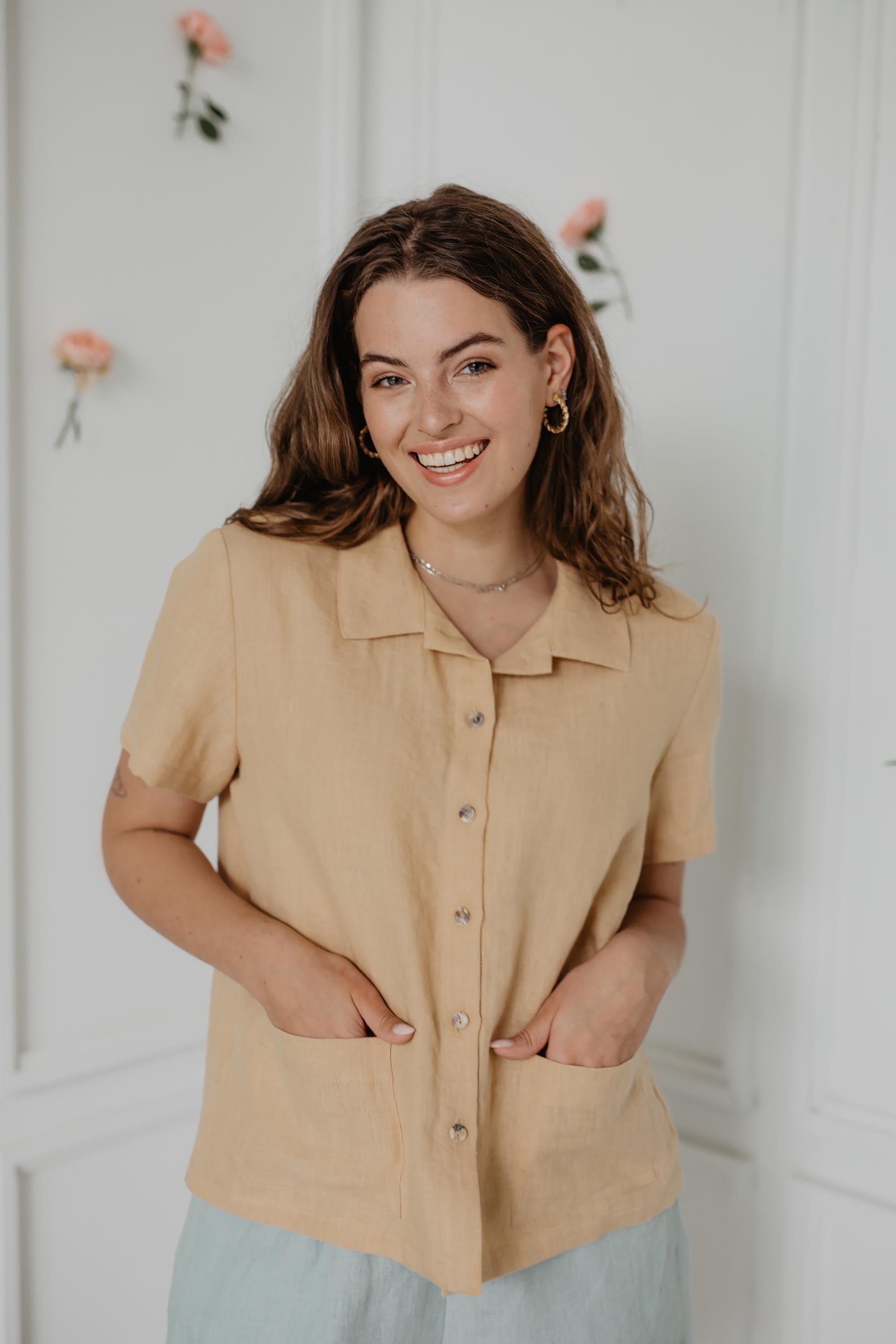 Smilling Woman Wearing A Mustard Color Summer Linen Shirt and Sage Green Linen Shorts
