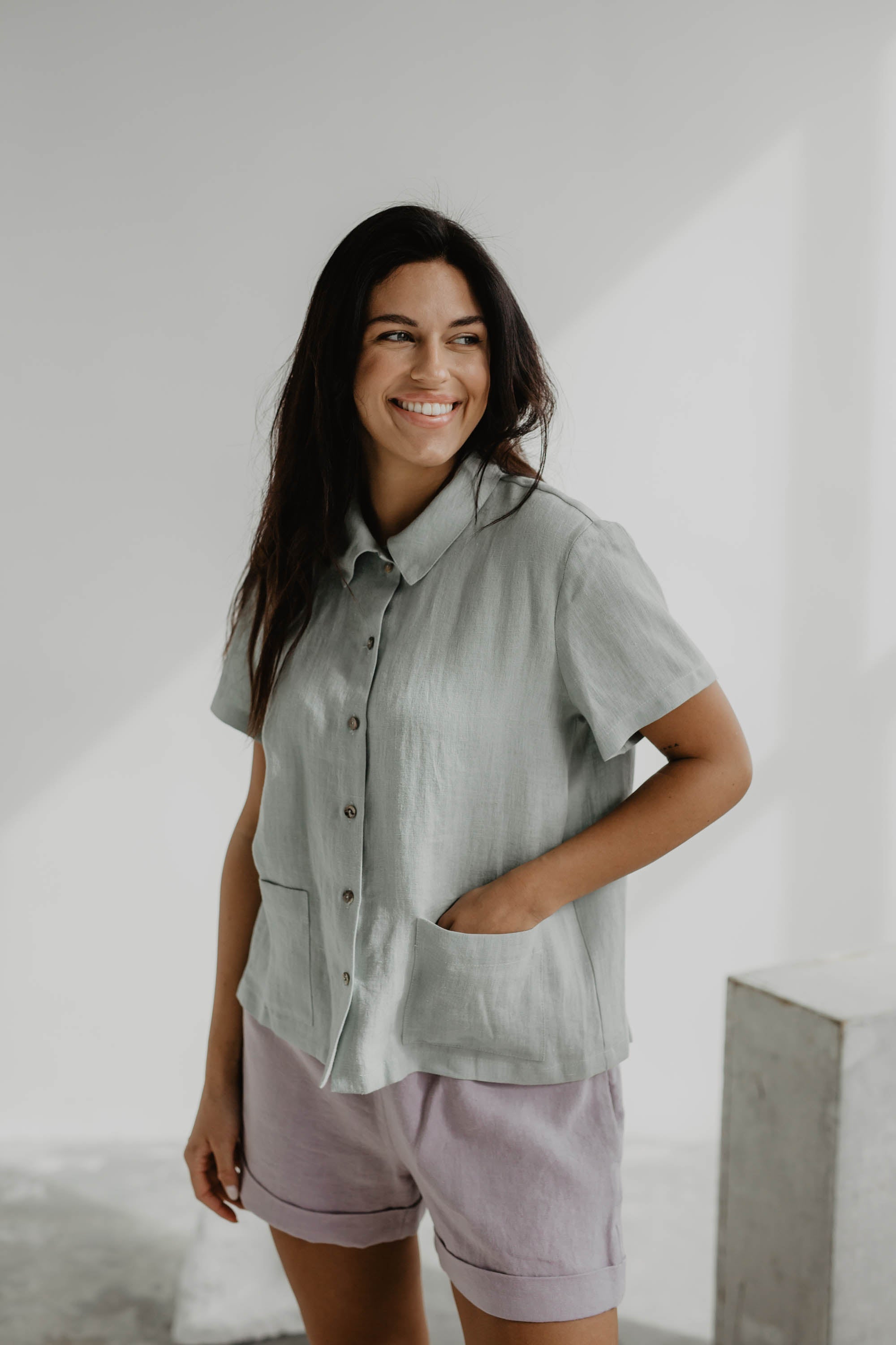Woman Wearing A Sage Green Linen Summer Shirt with Dusty Rose Linen Shorts