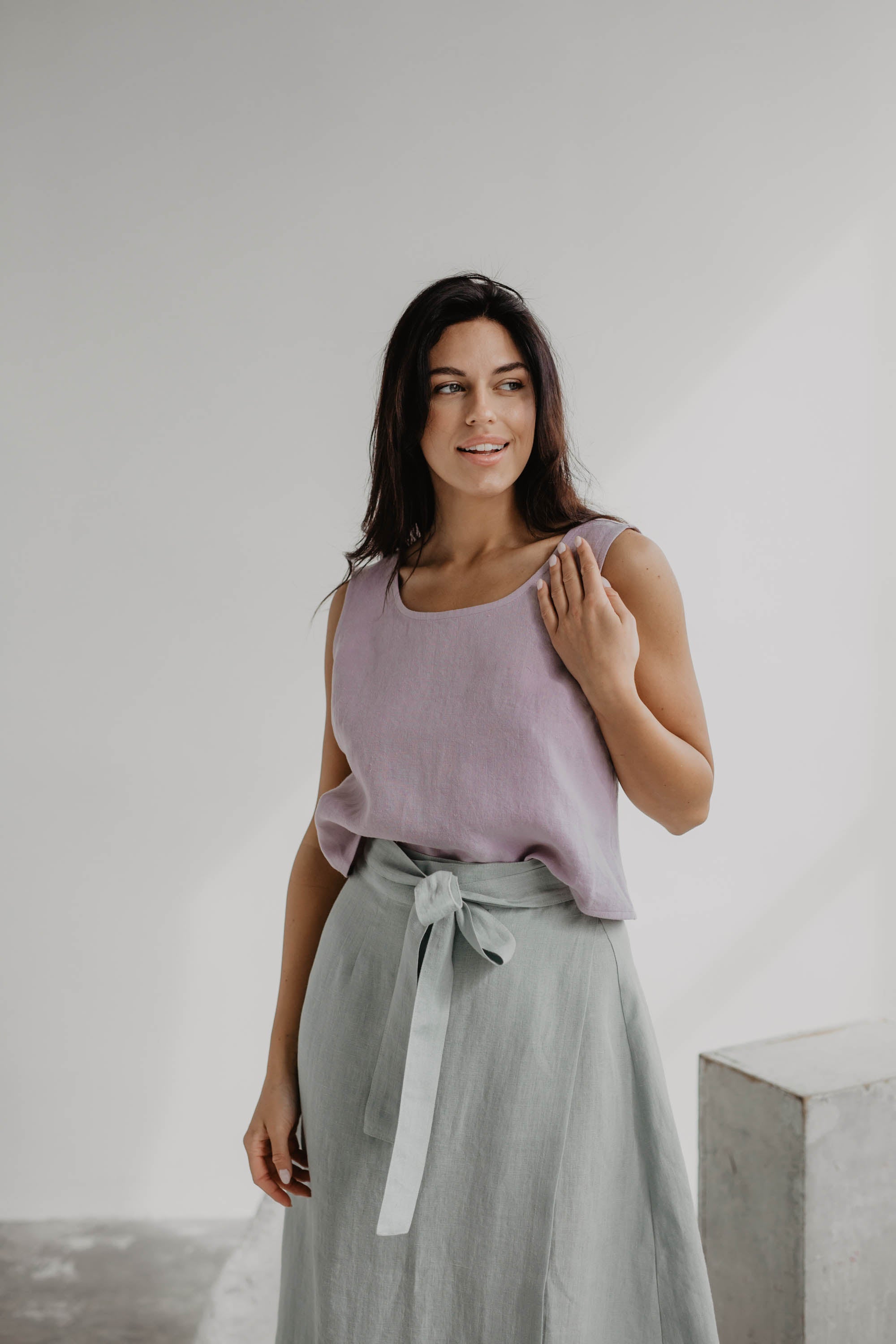 Woman Wearing A Dusty Rose Linen Top With A Sage Green Linen Skirt