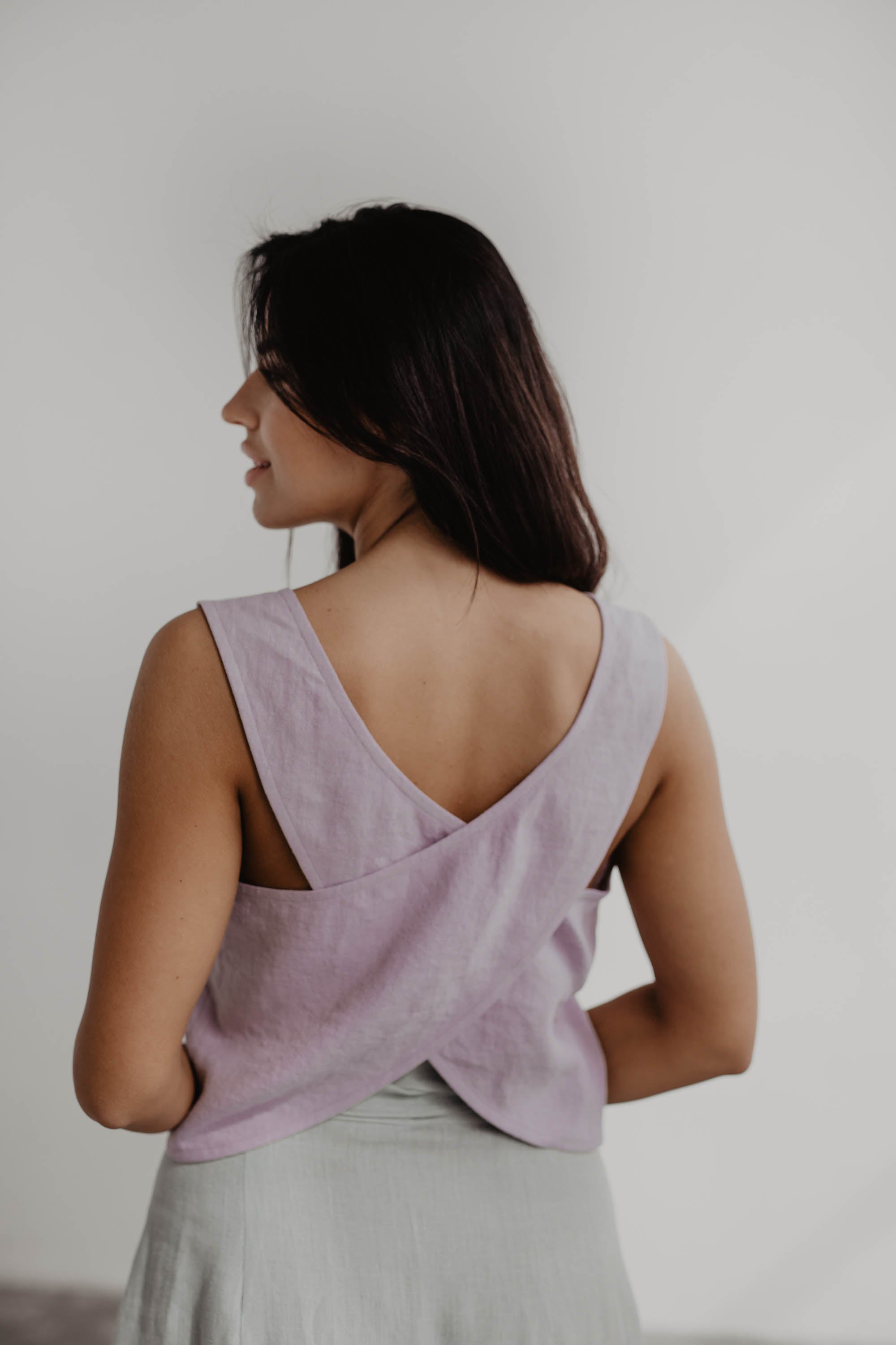 Back Close Up Of A Woman Wearing A Dusty Rose Linen Pinafore Top