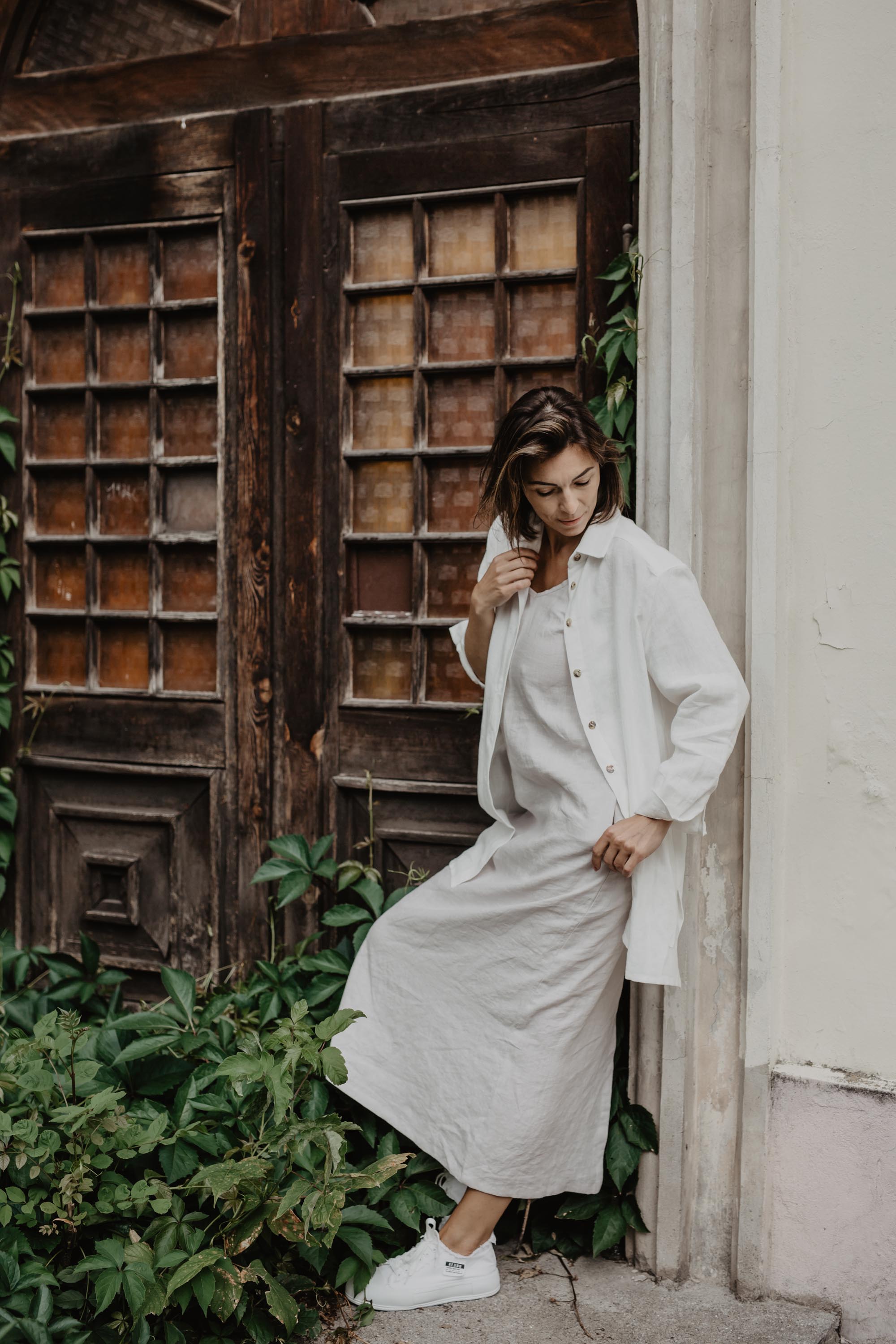 Woman Wearing a White Oversized LInen Shirt and Linen Dress By Amour lInen
