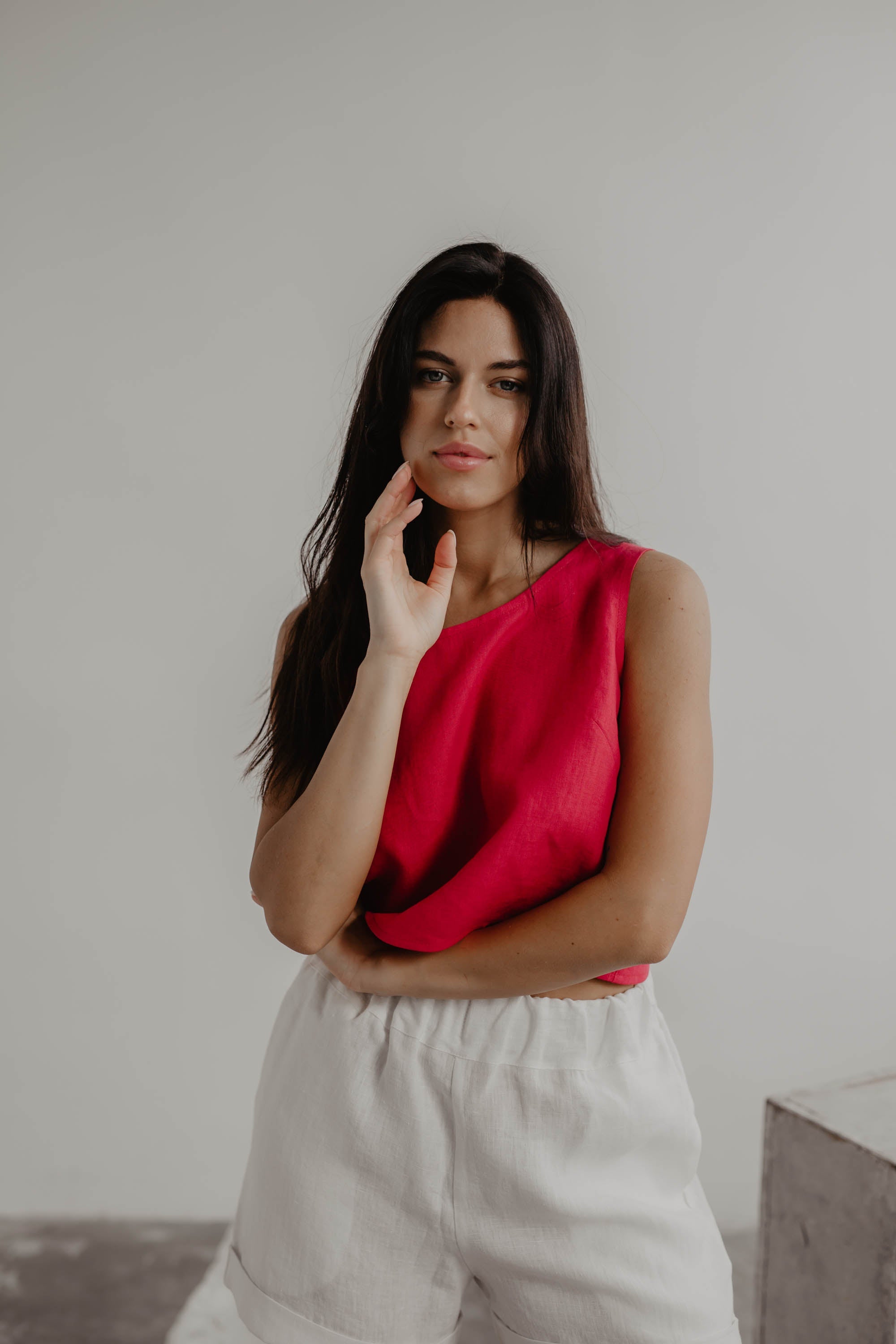Close Up Of Woman Posing In A Magenta Linen Top and White Linen Shorts