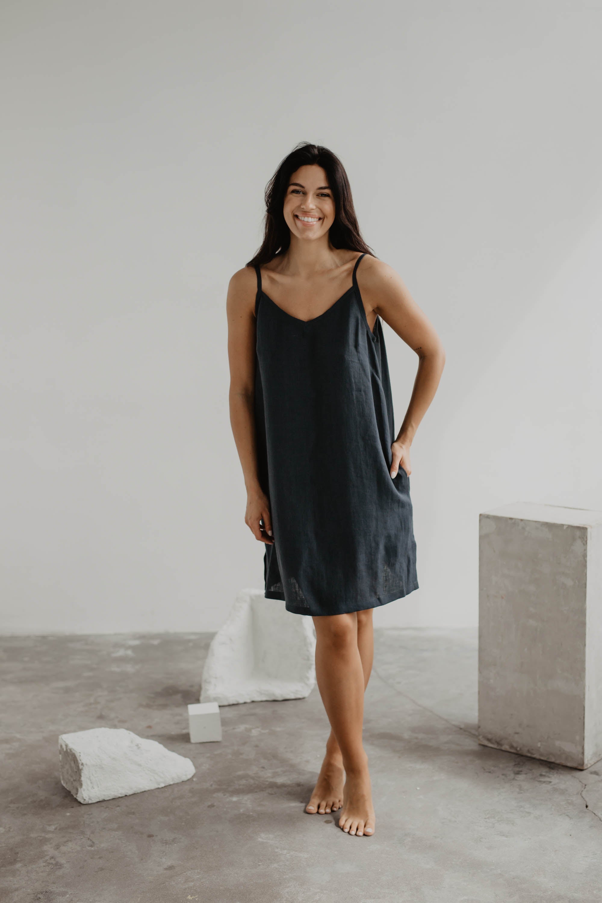 Women With Crossed Legs Wearing A Black Linen Slip Dess In Gallery by Amourlinen