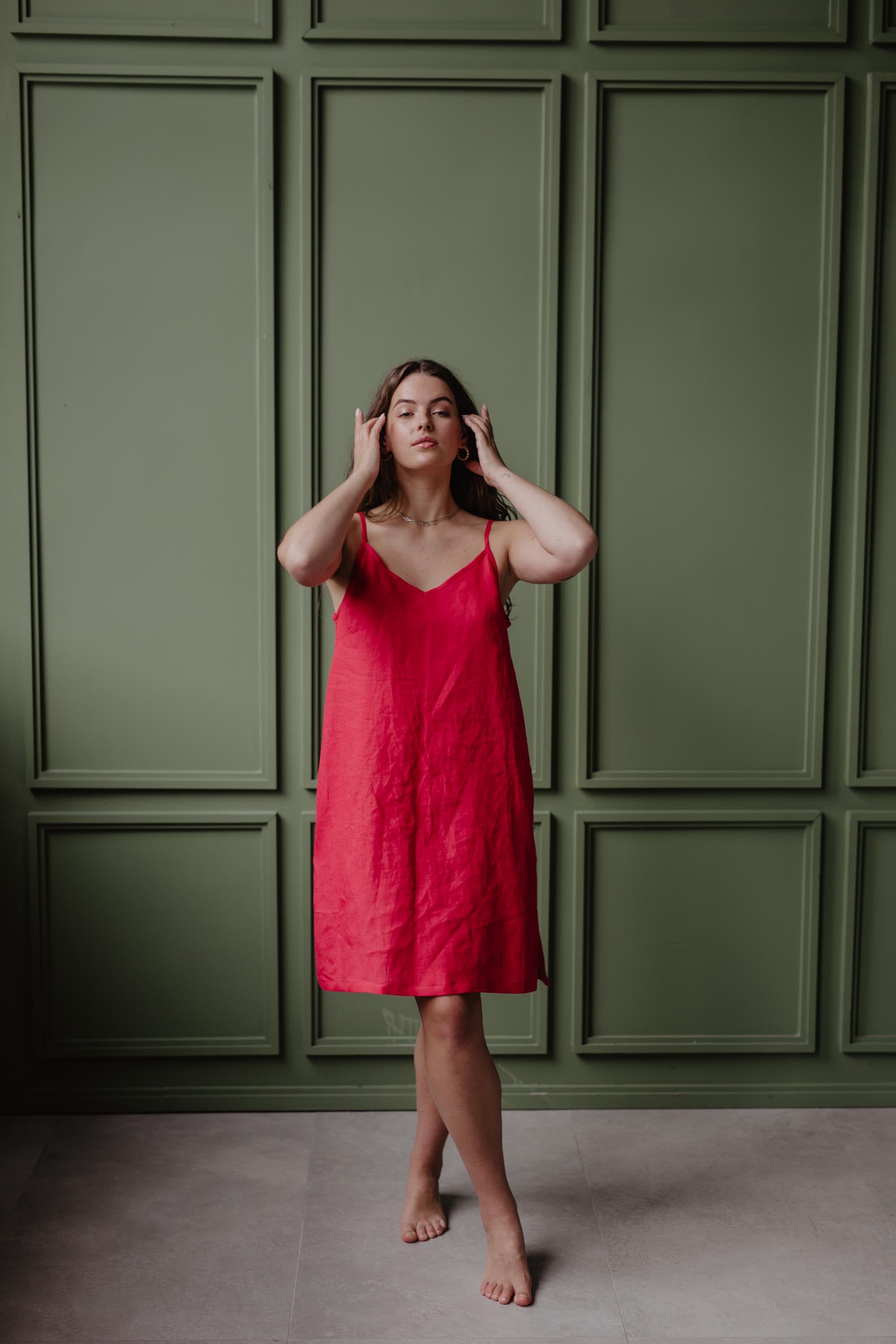 Women Wearing A Red Linen Slip Dress Adjusting Hair by Amourlinen