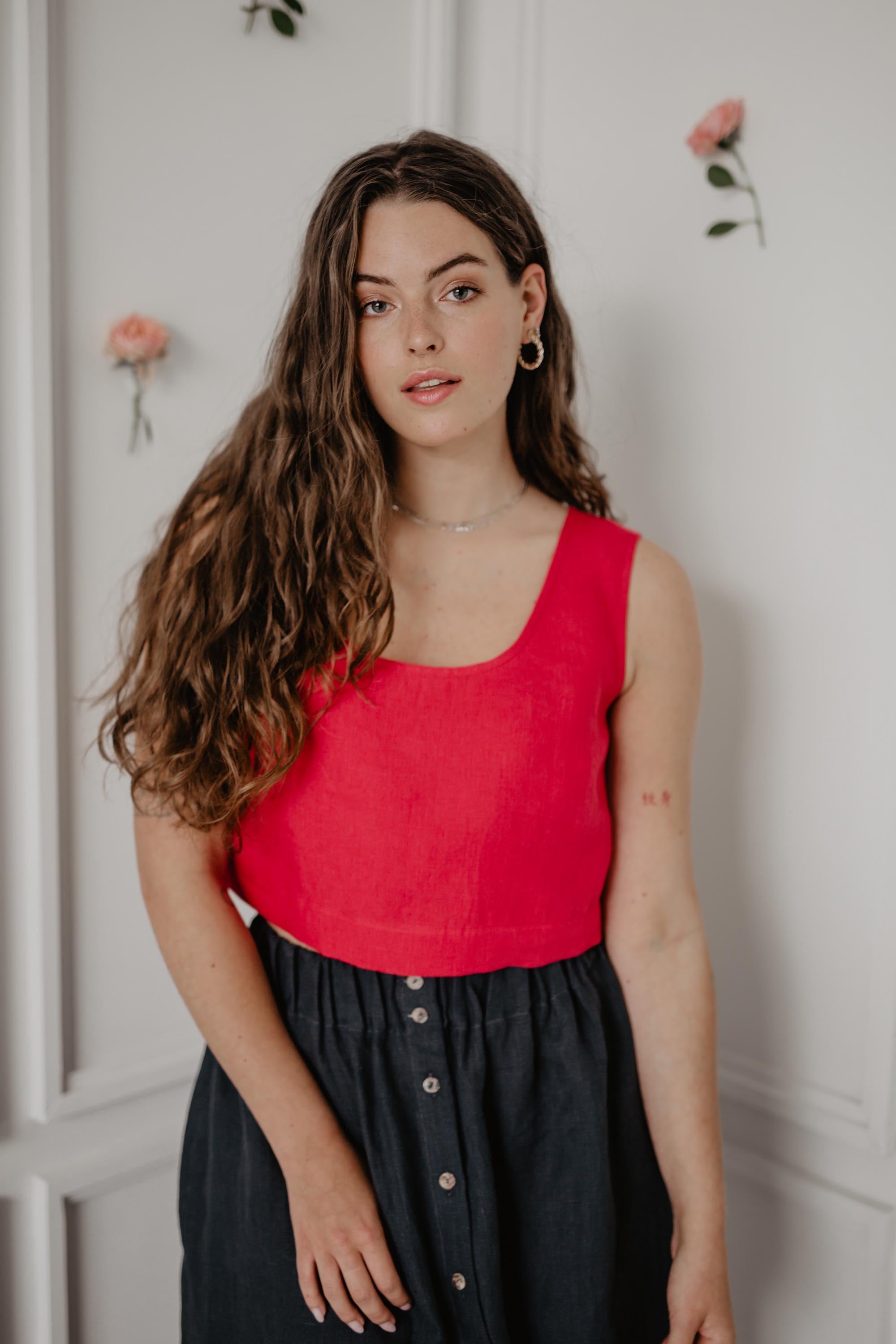 Close Up Of Woman Wearing A Red Linen Corp Top And Dark Linen Long Skirt