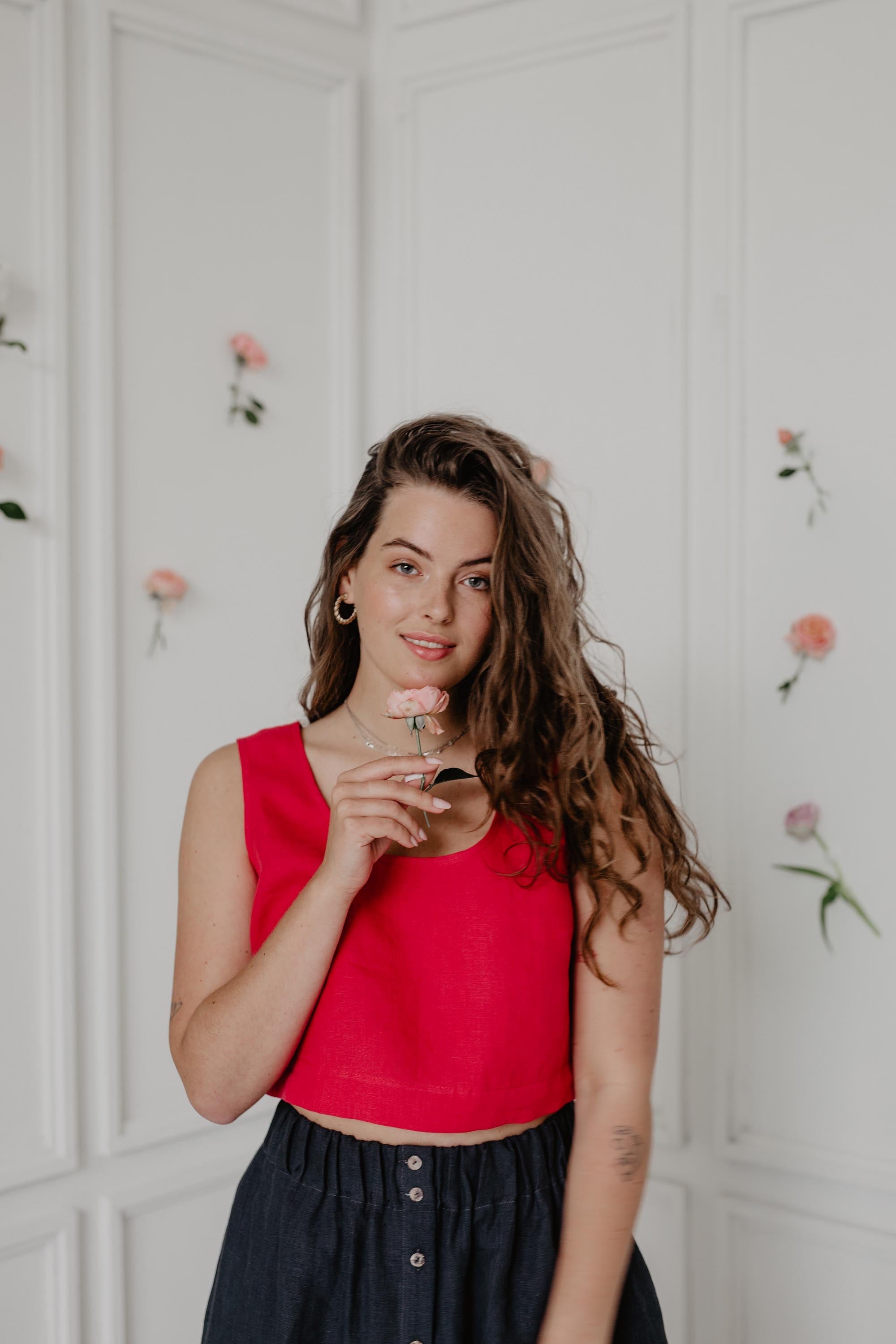 Woman Holding A Flower Wearing A Red Linen Crop Top