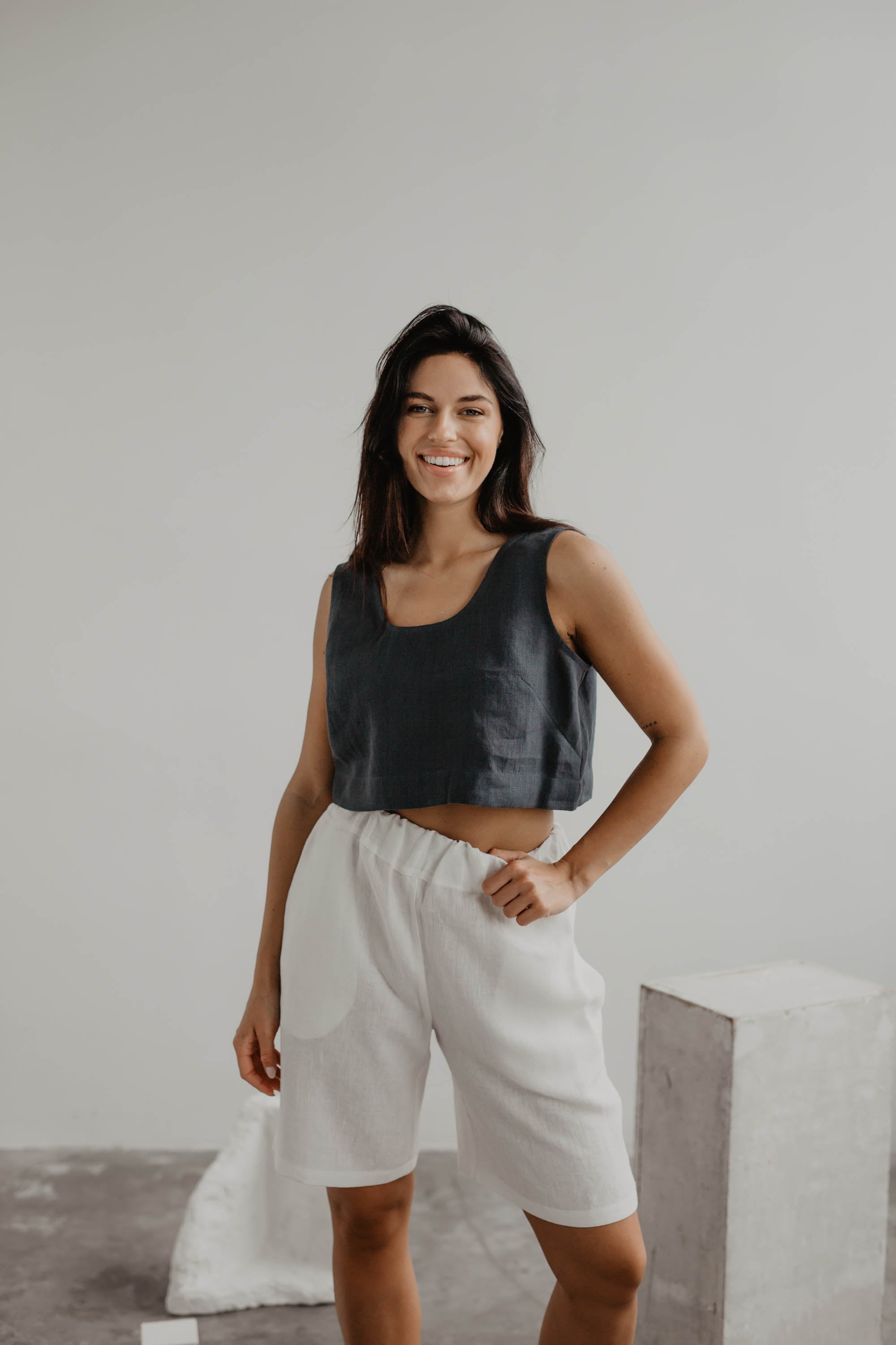 Woman Wearing A Dark Linen Crop Top And White Linen Shorts Facing Forward By AmourLinen